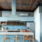 sky blue kitchen with blue tiles and wooden chair
