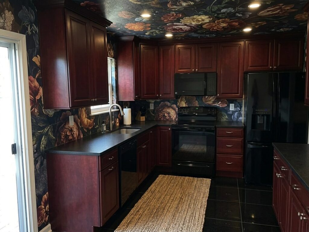 image showing kitchen with cherry wood cabinets, black countertops, floral wallpaper on walls and ceilings, and black tiles