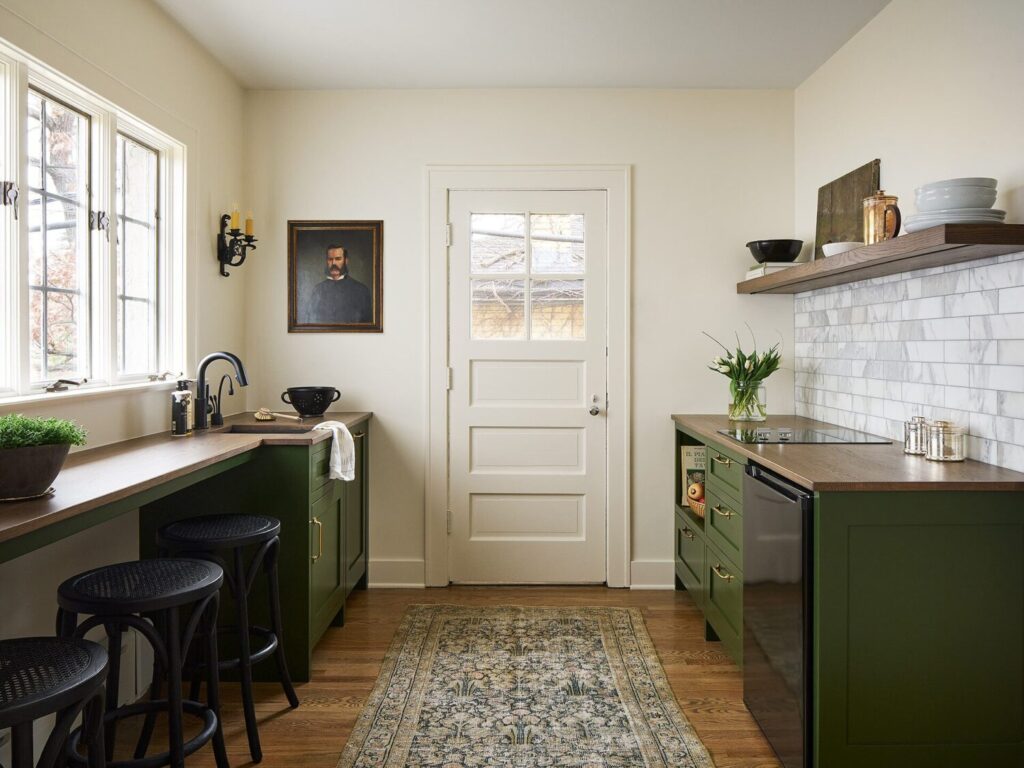 small kitchen with green cabinets